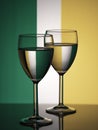 Two wine glasses silhouette full on irish flag background. Alcohol beverage Royalty Free Stock Photo