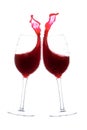 Two wine glasses in toasting gesture with big splashing. Isolated on white Royalty Free Stock Photo