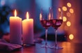 two wine glasses waiting near candles next to two candlesticks on a table