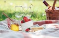 Two wine goblets, fresh strawberry, honey and wine are served for summer romantic picnic