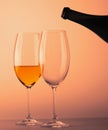 Two wineglass one half full of white wine black bottle Royalty Free Stock Photo