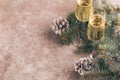 Two wineglasses of champagne with Christmas tree branches