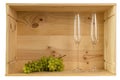 Two wineglasses for champagne and white grapes in a wooden box from wine bottles with copy space Royalty Free Stock Photo