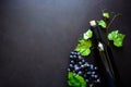 Two wineglasses with red wine, bottle and grape leaves lying on dark wooden background. Royalty Free Stock Photo