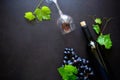 Two wineglasses with red wine, bottle and grape leaves lying on dark wooden background. Royalty Free Stock Photo