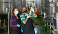 Two winemakers checking winemaking process at factory Royalty Free Stock Photo