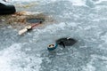 Two winter fishing rods lie on holes drilled in the ice. Winter fishing on the pond.