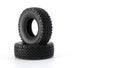 Two Winter off-road Tires in Stack for a Vehicle on a Clean White Background.