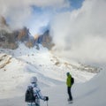 Two winter sports enthusiasts in the cloud covered mountains of the dolomites in South Tyrol