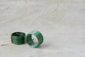 Two wire green thread inserts, free running on grey cement background. Stainless Steel. Horizontal with copy space for text and Royalty Free Stock Photo