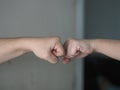 Two woman Alternative handshakes Fist collision Bump greeting in the situation of an epidemic covid 19, coronavirus