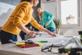 Two woman checking blueprints