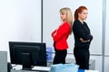 Two woman colegues in office angry to each other