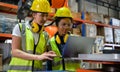 Two woman engineer checking the operation of a welding robot.