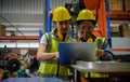 Two woman engineer checking the operation of a welding robot.