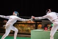 Two woman fencing athletes fight Royalty Free Stock Photo