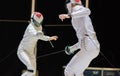 Two woman fencing athletes fight Royalty Free Stock Photo