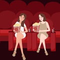 Two woman friends enjoy watching movies at cinema while eating popcorn friendship