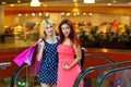 Two woman friends in shopping mall Royalty Free Stock Photo