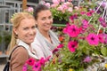 Two woman in garden center colorful flowers Royalty Free Stock Photo