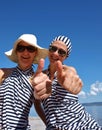 Two woman giving thumbs up