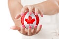 Two Woman Hands Protecting Canadian Flag Earth Globe Sphere. Royalty Free Stock Photo