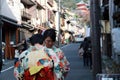 Two woman in Kimono dress on the way to Fushimi Inari Shrine, in Kyoto people will wear national uniforms to worship at temple. Royalty Free Stock Photo