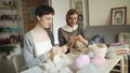 Two woman knitter working together in textile workshop. Woman leisure knitting