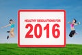 Two Woman Showing Healthy Resolution for 2016 Royalty Free Stock Photo