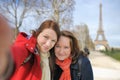 Two woman taking selfie near the Eiffel tower Royalty Free Stock Photo