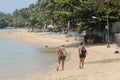 Two woman walking on Bophut beach  in Koh Samui, Thailand.. Royalty Free Stock Photo