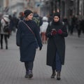 Two womans in black coats walking on street of old town 14-08-2018 Riga, Latvia