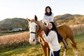 Two Womans with her horse at sunset, autumn outdoors scene Royalty Free Stock Photo