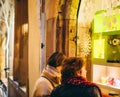 Two women admiring the windows shopping for Christmas