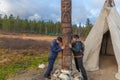 Two women ask the gods of happiness, health, wealth in alley of the gods, Sami, saami village on the Kola Peninsula, Russia. Royalty Free Stock Photo