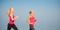 Two women athlets running on the beach - early morning summer w Royalty Free Stock Photo