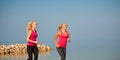 Two women athlets running on the beach - early morning summer w Royalty Free Stock Photo