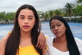 Two women, beautiful modern ladies standing on the city street