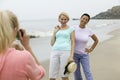 Two women being photographed on beach