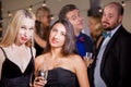 Two Women Being Watched by Men at Party Royalty Free Stock Photo