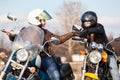 Two women bikers greeting each other with fists blow, usually gesture of motorcyclists Royalty Free Stock Photo