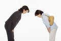 Two women bowing, facing each other