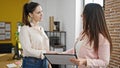 Two women business workers reading document shake hands at office Royalty Free Stock Photo