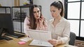 Two women business workers reading document working at office Royalty Free Stock Photo