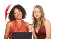 Two women: Christmas online shopping using laptop Royalty Free Stock Photo