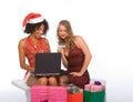 Two women: Christmas online shopping using laptop Royalty Free Stock Photo