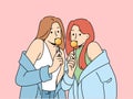 Two women with chupa chups in hands dressed in fashionable seductive clothes eat lollipops