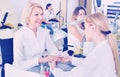 Two women clients having manicure done in nail salon Royalty Free Stock Photo