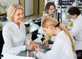 Two women clients having manicure done in nail salon Royalty Free Stock Photo