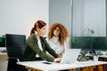 Two women coding together in a high-tech office, showcasing teamwork, software development, and female empowerment Royalty Free Stock Photo